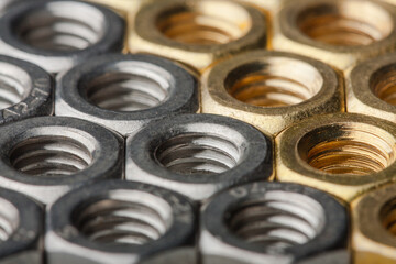 Metallic hex nuts layed out in a hexagonal pattern