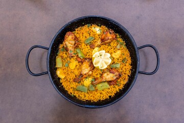 Top view of Paella served on a pan in a restaurant
