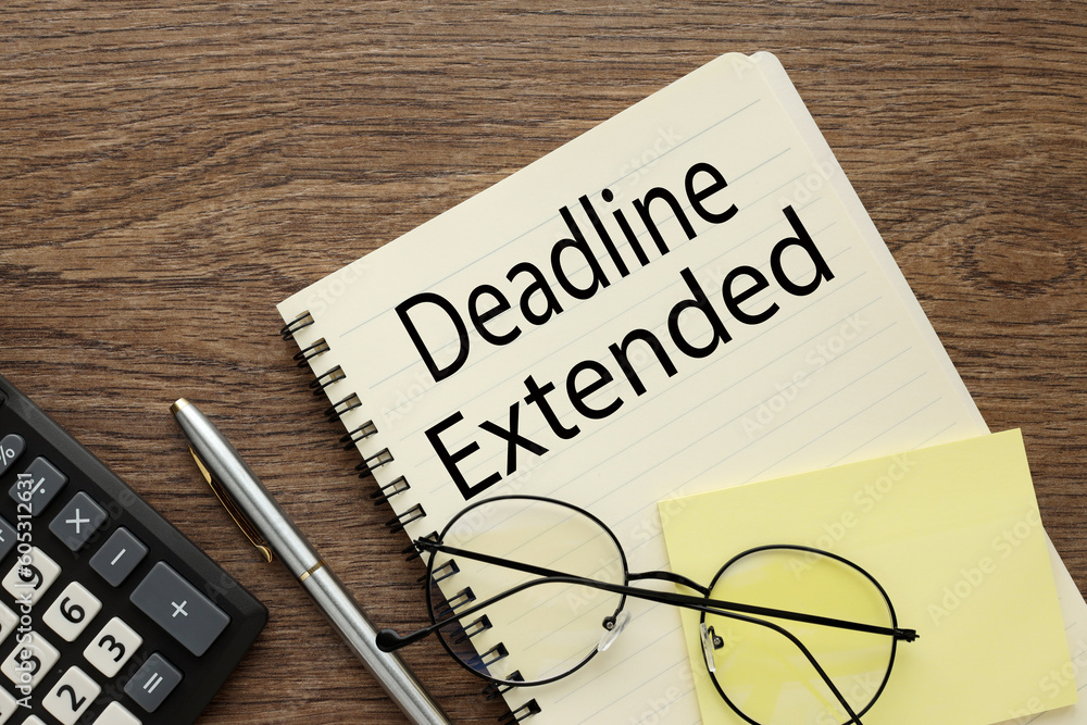 Poster view from above. text deadline extended on page in notepad on desktop