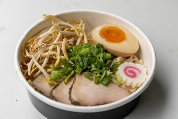 Closeup of bowl with different ingredients in white background