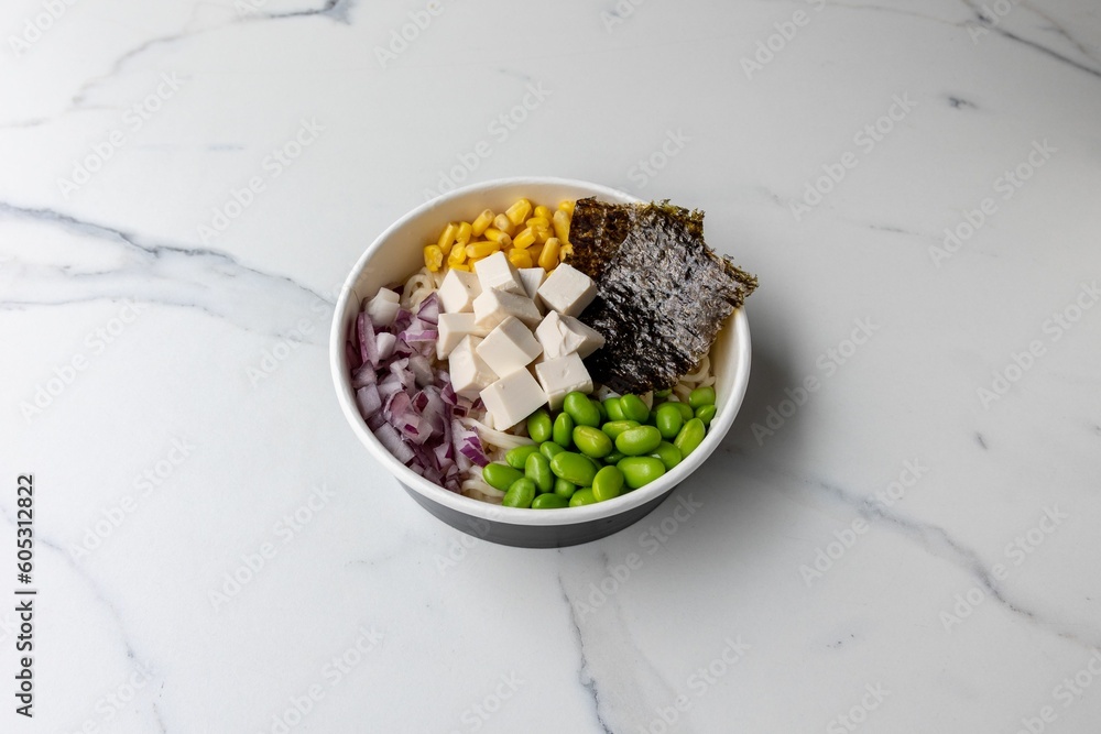 Poster Tasty poke bowl with tofu cheese on the marble table