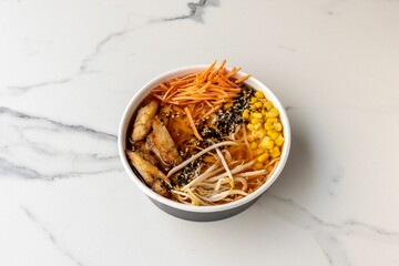 Top view of a tasty poke bowl with corn on the marble table