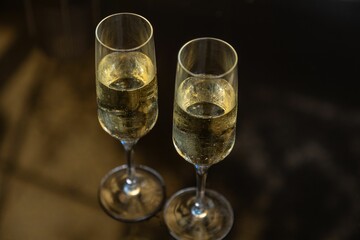 Closeup of two wine glasses full of champagne put on the table