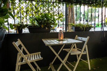 Elegant white lantern on a wooden table in a restaurant