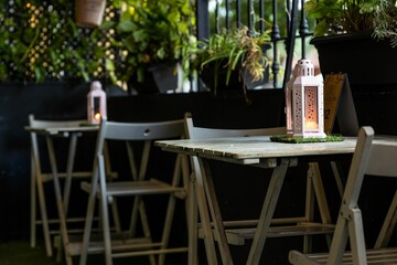 Elegant white lantern on a wooden table in a restaurant