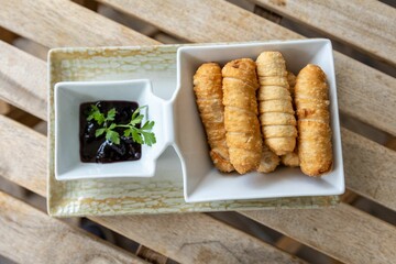 Closeup of crunchy rolls with plum sauce