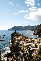 Fototapeta na wymiar Vertical shot of the coastal village and mountainous islands in Vernazza, Cinque Terre, Italy