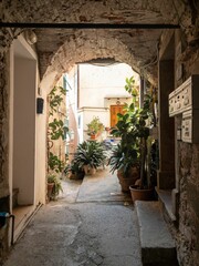 Fototapeta na wymiar Vertical shot of an archway leading to a garden in Vernazza, Cinque Terre, Italy