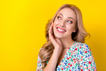 Fototapeta premium Photo of dreamy pretty lady wear flower print dress arm cheek looking empty space isolated yellow color background