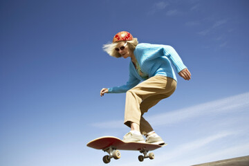 Senior woman skateboarding against blue sky, generative ai