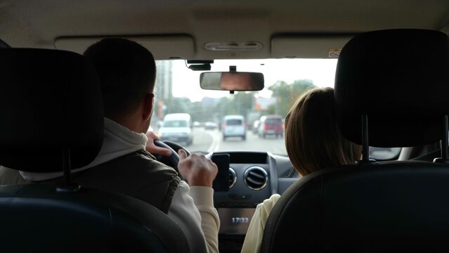 Adult Man Driving Car And Dancing With Little Teen Daughter Moving Hands To Rhythm. Close Up Of Father With Kid Girl In Vehicle During Travel. Fun, Road Trip. Back View. Slow Motion. Journey