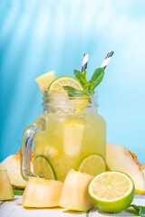 Melon lemonade or mojito, melon and lime juice, with crushed ice, fruit slices garnished with mint...