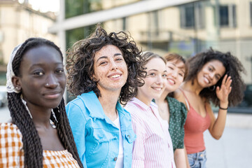 Fototapeta premium Five young teenager in a row, focus on brunette girl with freckles