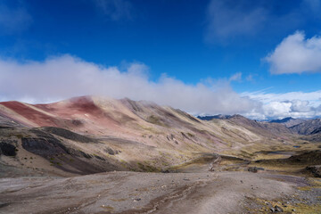 rainbow mountains in peru with clouds - view on the way