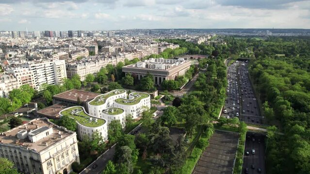 Afternoon traffic in Paris with Bois de Boulogne Park, aerial shot