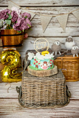 farm style decoration for a birthday cake smash studio photo shoot with flowers, decor, cake and topper on white wooden background