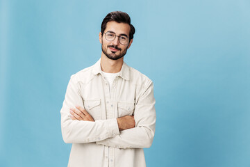 Portrait of a stylish man smile with teeth in glasses for farsightedness and myopia, on a blue background in a white T-shirt, fashionable clothing style, space space