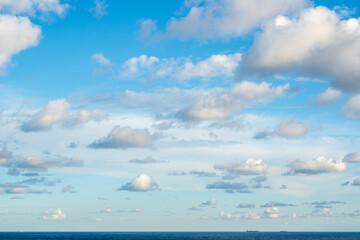 bright sky with clouds over the ocean with ships