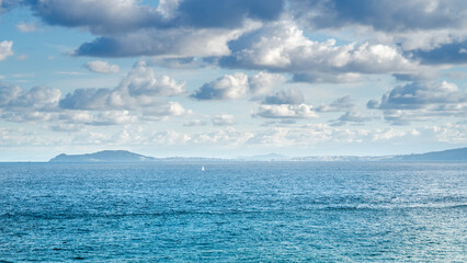 bright sky with clouds over the ocean by Gibraltar with ships