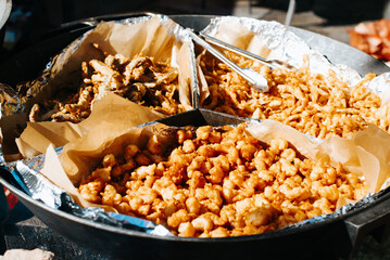 Fried delicious snacks in a cauldron outdoors