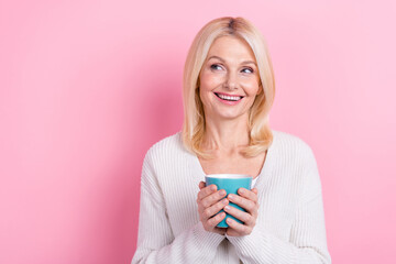 Photo of positive minded person hands hold fresh coffee cup look empty space isolated on pink color background