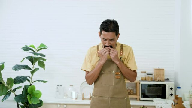 Male chef using paring knife peel large mango, said so quickly that it caused an accident, paring knife cut his finger causing wound, was in lot pain use mouth suck blood from finger, stop bleeding.
