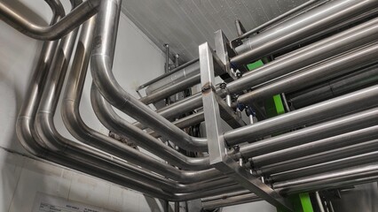 Stainless steel pipes in production room of factory