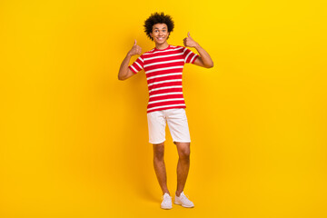 Fototapeta na wymiar Full body photo of young hipster guy raise hands arms thumbs up wear summer shirt pants isolated yellow color background