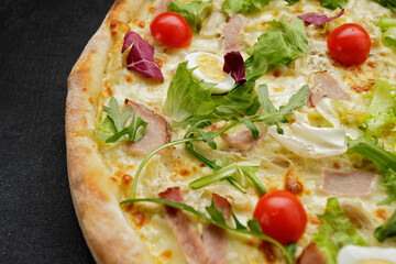 pizza with meat. tomatoes, quail eggs, and herbs. deluxe pizza