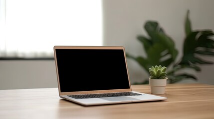 Fototapeta premium Laptop with blank screen on table workspace laptop showing blank screen background