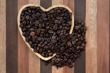 coffee beans in heart-shaped tra,y representing love of coffee