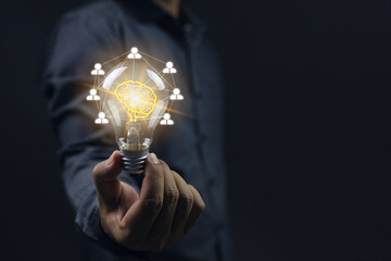The incandescent bulb represents the brain and the teamwork conveys the brainstorming of new...