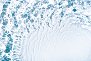 The texture of water on a white background in bright sunlight.