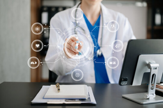 medical technology concept,smart doctor hand working with modern laptop computer with his team virtual icon .