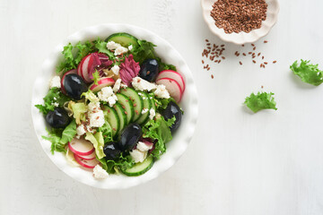 Lettuce salad, cucumber, radish salad with cottage cheese and flax seeds olive oil salad. Healthy diet food. Diet menu and balanced diet. Top view.