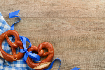 Oktoberfest concept card. Traditional Bavarian pretzels with beer bottle mug on old rustic wooden background. Perfect for Octoberfest. Oktoberfest food menu. Top view. Mock up.