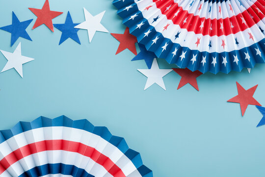4th of July background. USA paper fans, Red, blue, white stars and confetti on blue wall background. Happy Labor Day, Independence Day, Presidents Day. American flag colors. Mock up. Top view.