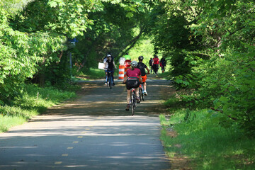 People cycling, Jogging and walking on the bikeway in the sunny day - obrazy, fototapety, plakaty
