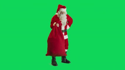 Studio Shot Isolated Mockup Template: Santa Claus Putting Down Bag With Gifts For All Good Children On Green Screen Chromakey Background And Waving To Camera In Slow Motion. Christmas And New Year
