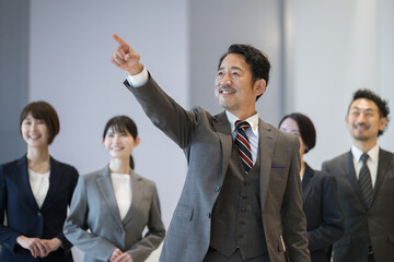Image of a cool president or representative pointing to the future with employees