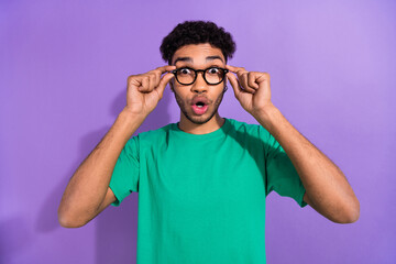 Photo of impressed funky guy dressed green t-shirt hands arms eyewear big eyes isolated violet color background