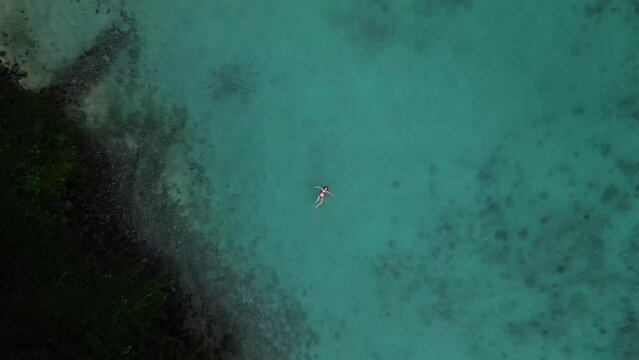 A tourist floats on the clear waters of the beaches of Koh Phi Phi Thailand