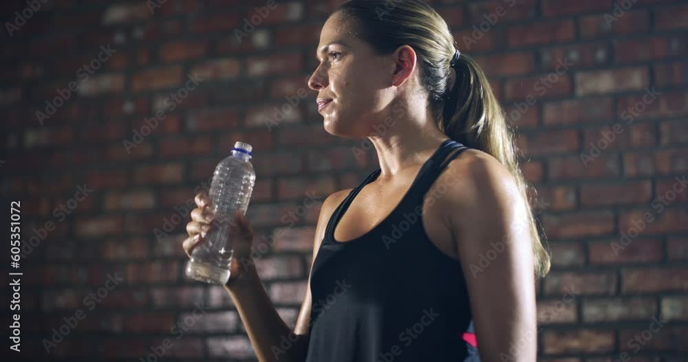 Poster Relax, fitness or girl drinking water in training, workout or exercise to hydrate her body in gym studio. Fatigue, wellness or tired woman with a bottle for healthy liquid hydration on resting break