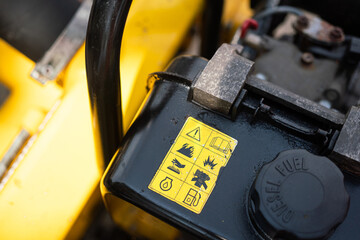 Safety caution and hazardous sign about the burning or flamming of the diesel fuel tank of the...