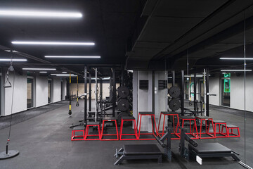Fototapeta na wymiar An empty modern gymnasium with a variety of equipment, offering a spacious, functional, and well-equipped training facility for workouts, fitness, and strength training