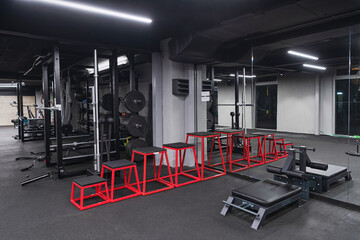 Fototapeta na wymiar An empty modern gymnasium with a variety of equipment, offering a spacious, functional, and well-equipped training facility for workouts, fitness, and strength training