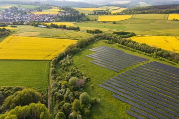 Aerial view of flowering rapeseed fields and solar panels in the Taunus near Taunusstein - Germany...