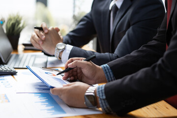 Business people meeting with business consultants to analyze investment situations and plan business marketing. Analyzing financial accounts and planning budgets.