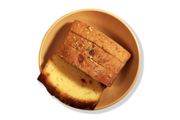 Sliced fruit cake in a cup with white background.