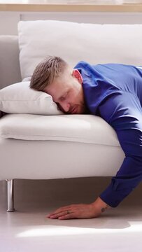 Exhausted Man Falling Asleep On Couch